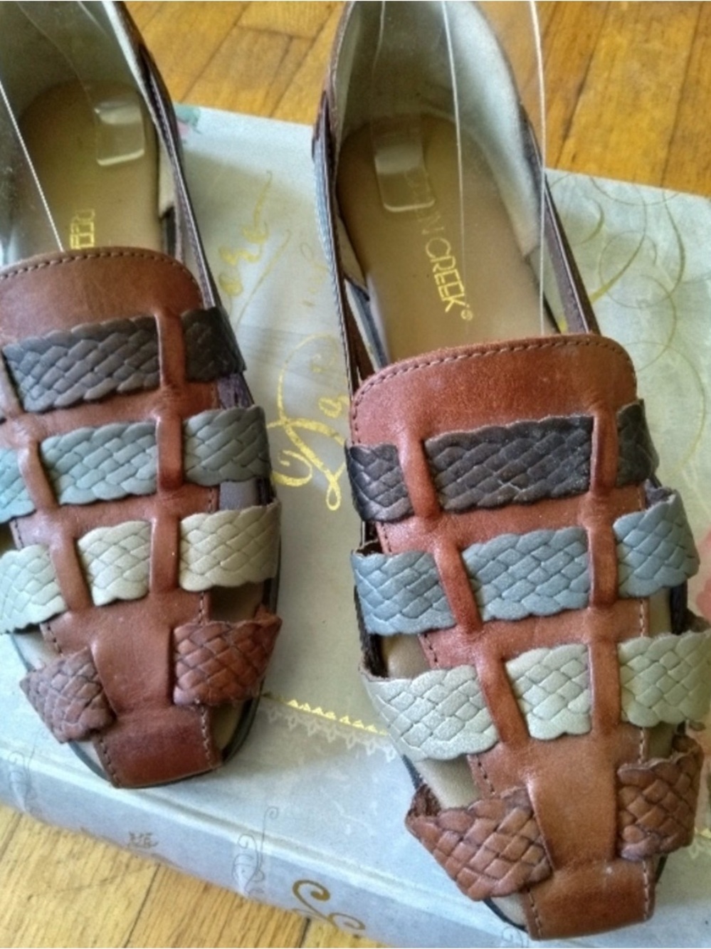 Flat leather loafers with multicolored woven straps